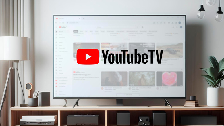 A television displaying the YouTube TV logo sits on a stand in what looks like a living room, the display is surrounded by lights, and multiple devices sit in the cubbies of the stand