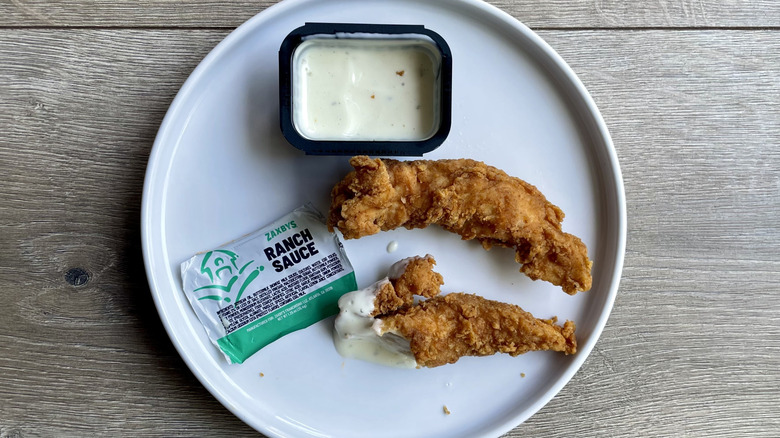 Chicken fingers with ranch sauce on a plate