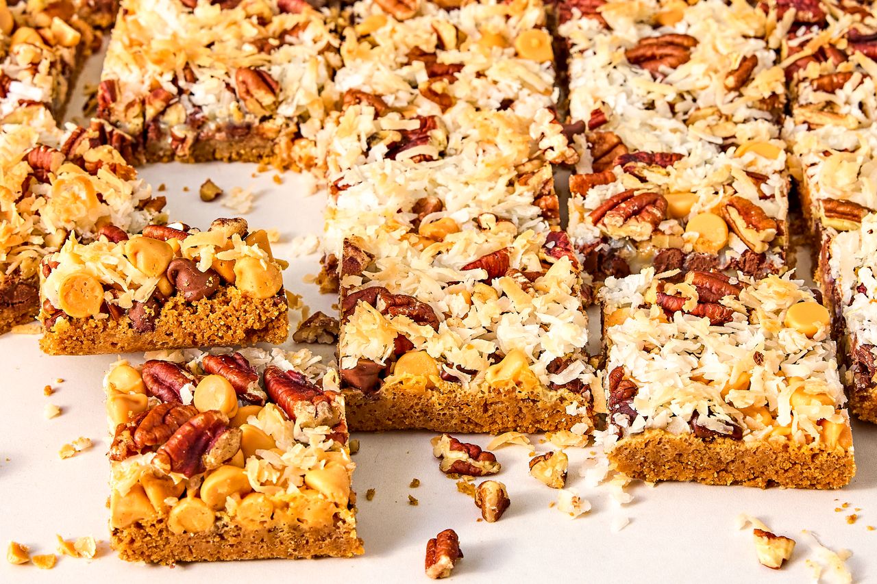 Sliced sevenlayer bars topped with coconut nuts and chocolate chips