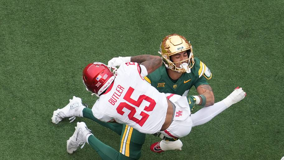 Houston Cougars running back DJ Butler (25) is tackled by Baylor Bears safety Micah Gifford (24)