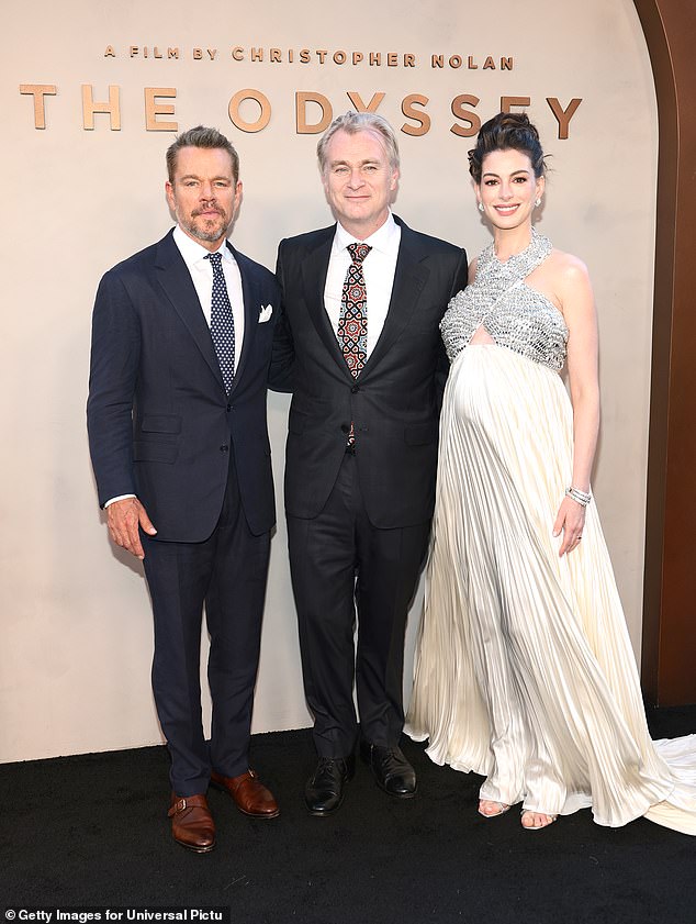 Matt Damon revealed that iconic director Christopher Nolan had 'waterboarded' him while filming The Odyssey, as the two are pictured with Anne Hathaway at the premiere in New York on Tuesday
