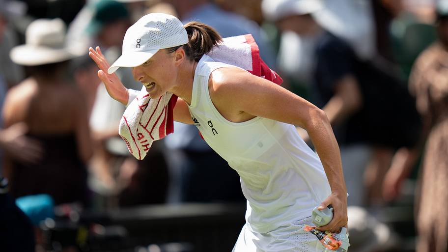 Iga Swiatek yells as she walks off of the court at Wimbledon.