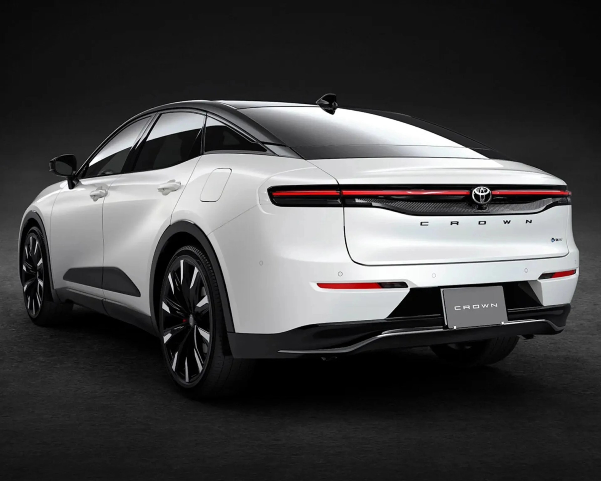 White Toyota Crown car rear with black roof, sleek taillights, and black alloy wheels on a dark background.
