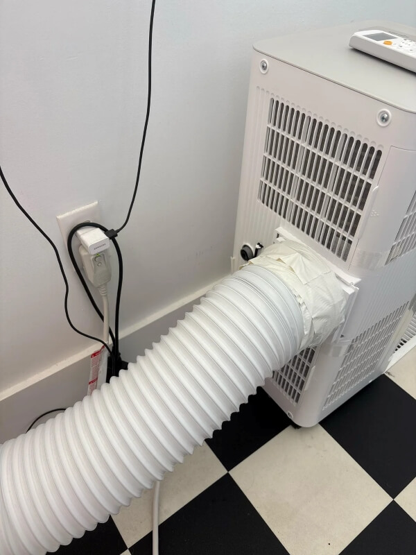 An exhaust hose connected to an AC.