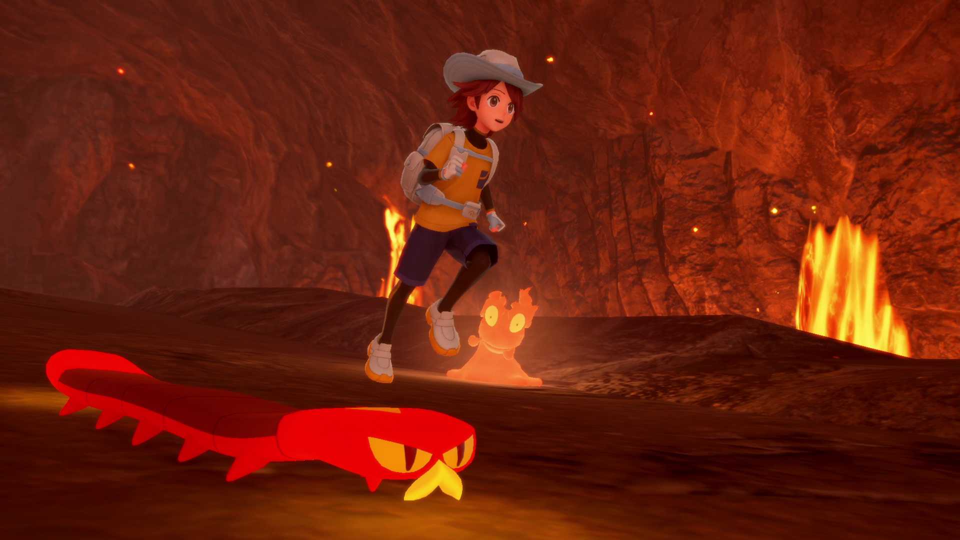 A Trainer from Pokemon Winds and Waves runs through a lava cave next to a Slugma and a Sizzlipede.