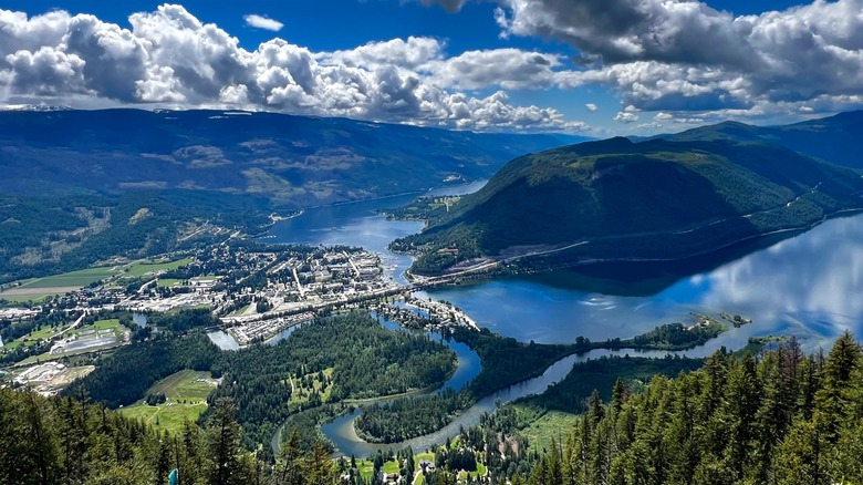 A view from a lookout above Sicamous, showing the thin channel, blue lakes, and rolling Canadian forests all around