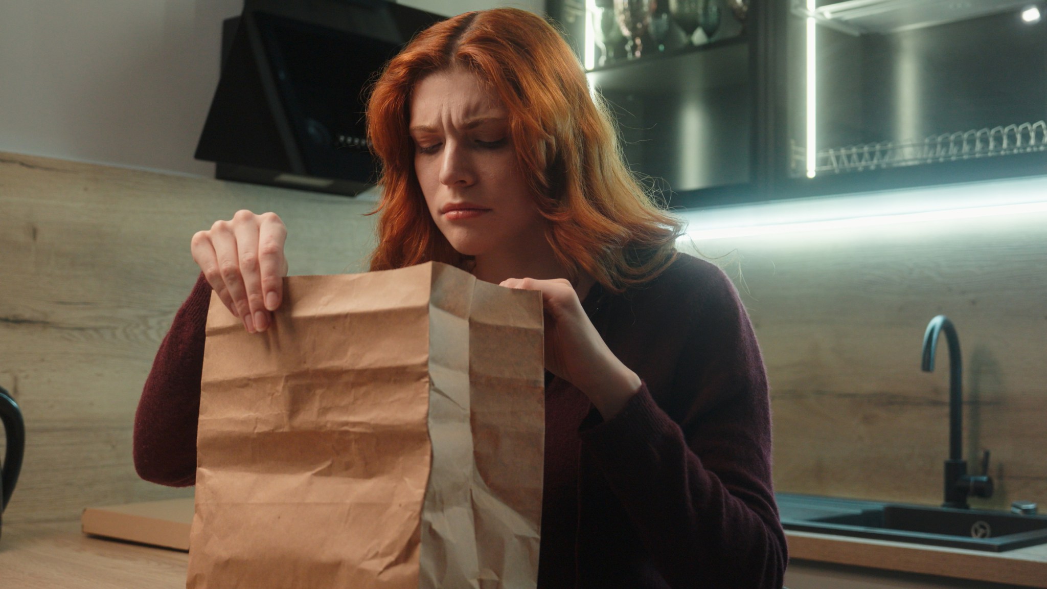 Shocked disgusted Caucasian hungry woman female client girl customer unpacking open paper bag order package sniff spoiled stink order bad smelling dish dislike smell feel nausea disgust indoor kitchen