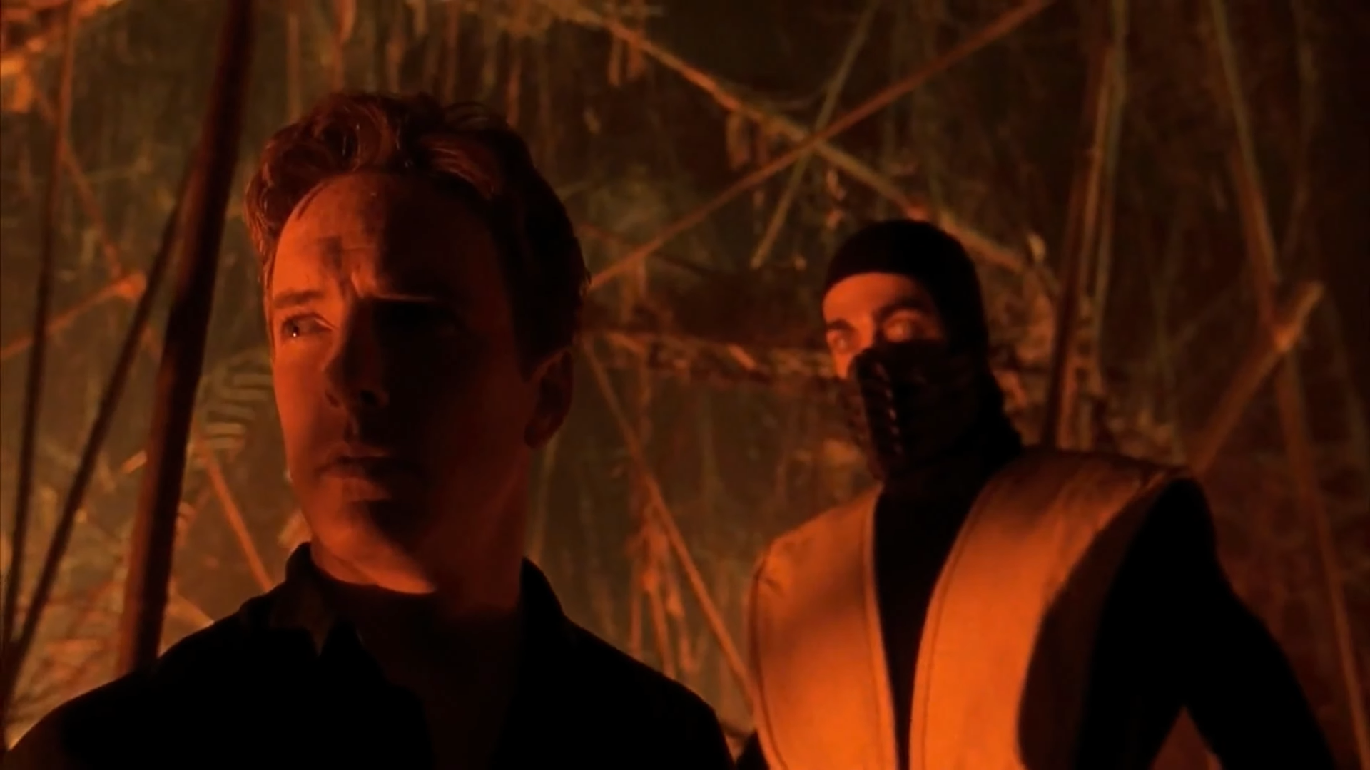 Scorpion standing behind Johnny Cage in Mortal Kombat (1995)