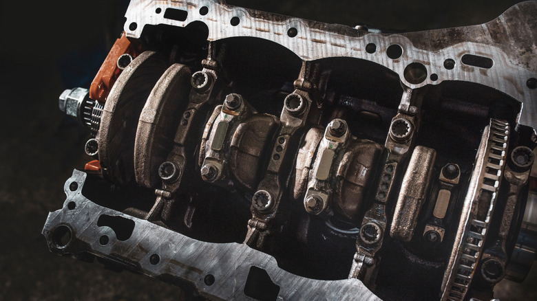 Engine block with oil pan removed showing crankshaft and connecting rod elements
