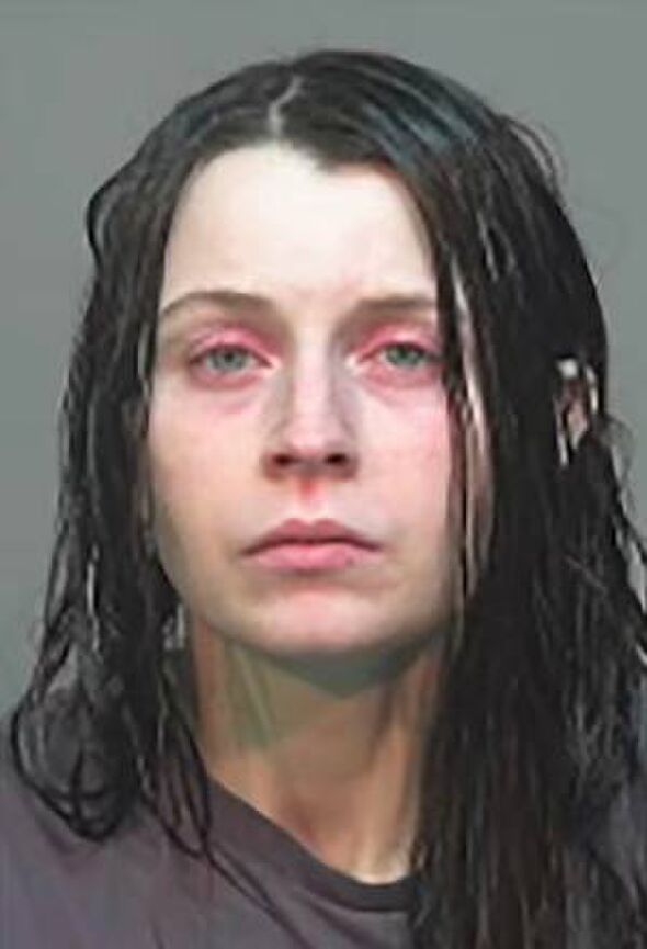 An image featuring a close-up of an individual's face, displaying wet hair and a somber expression. The individual's eyes are sl