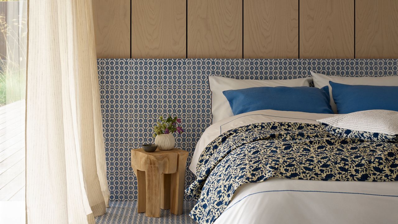 A contemporary bedroom with tiled and wood-paneled walls