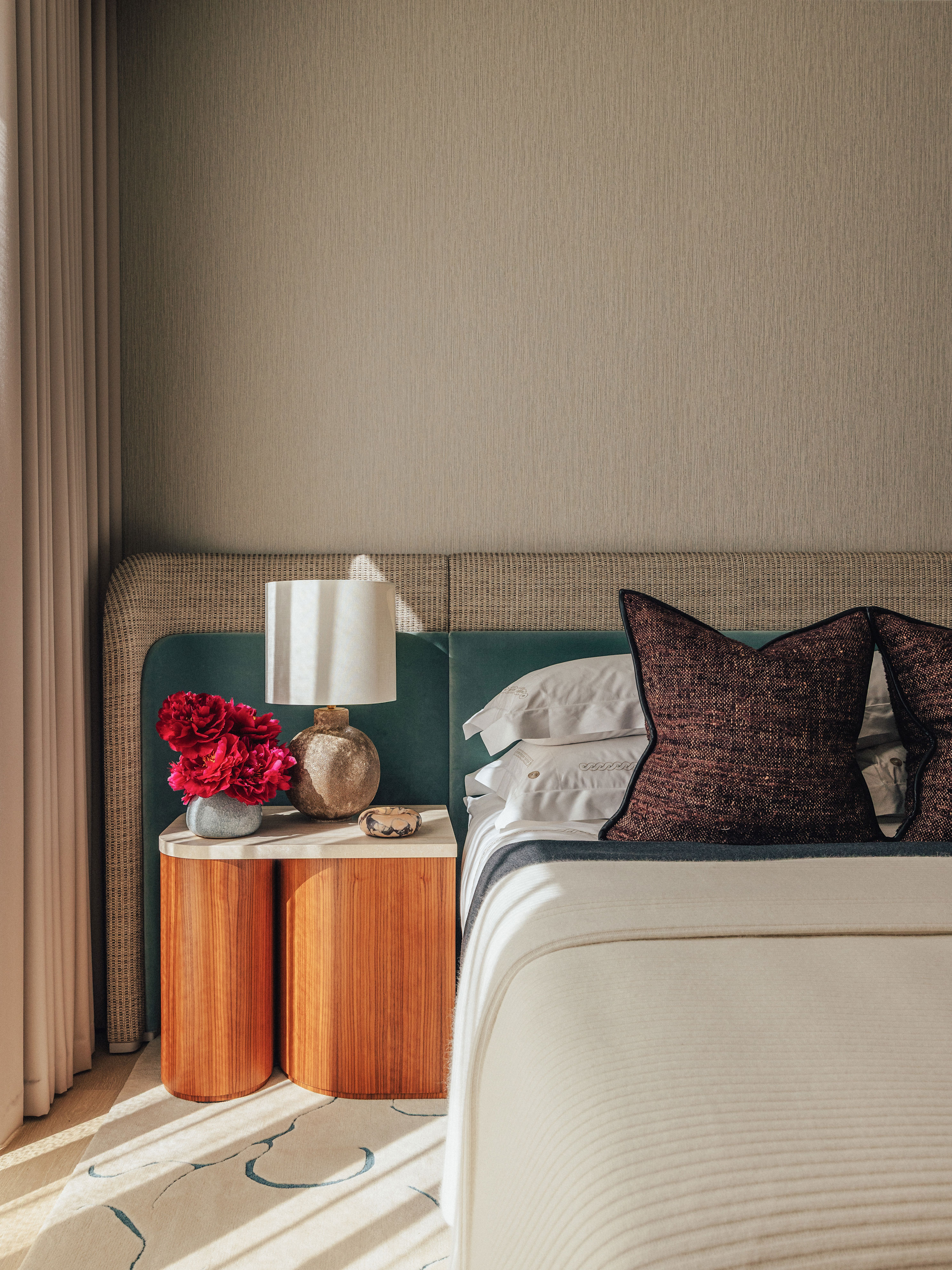 A contemporary bedroom with elegant grained wallpaper in silver-grey