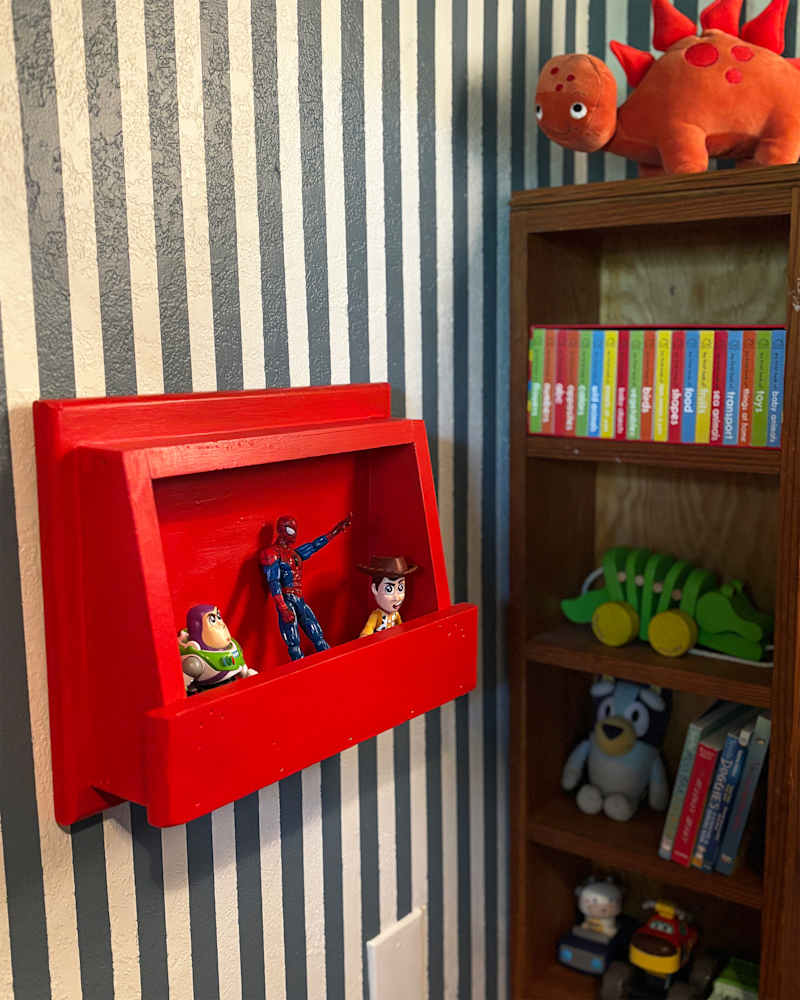 Toys on display in red shelf.