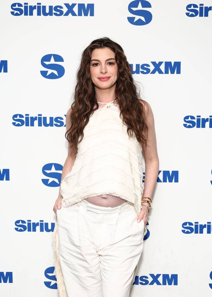 A close-up photo of Anne Hathaway wearing white