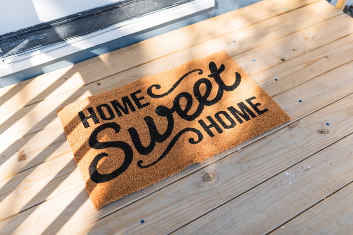 Home sweet home mat on a wooden porch