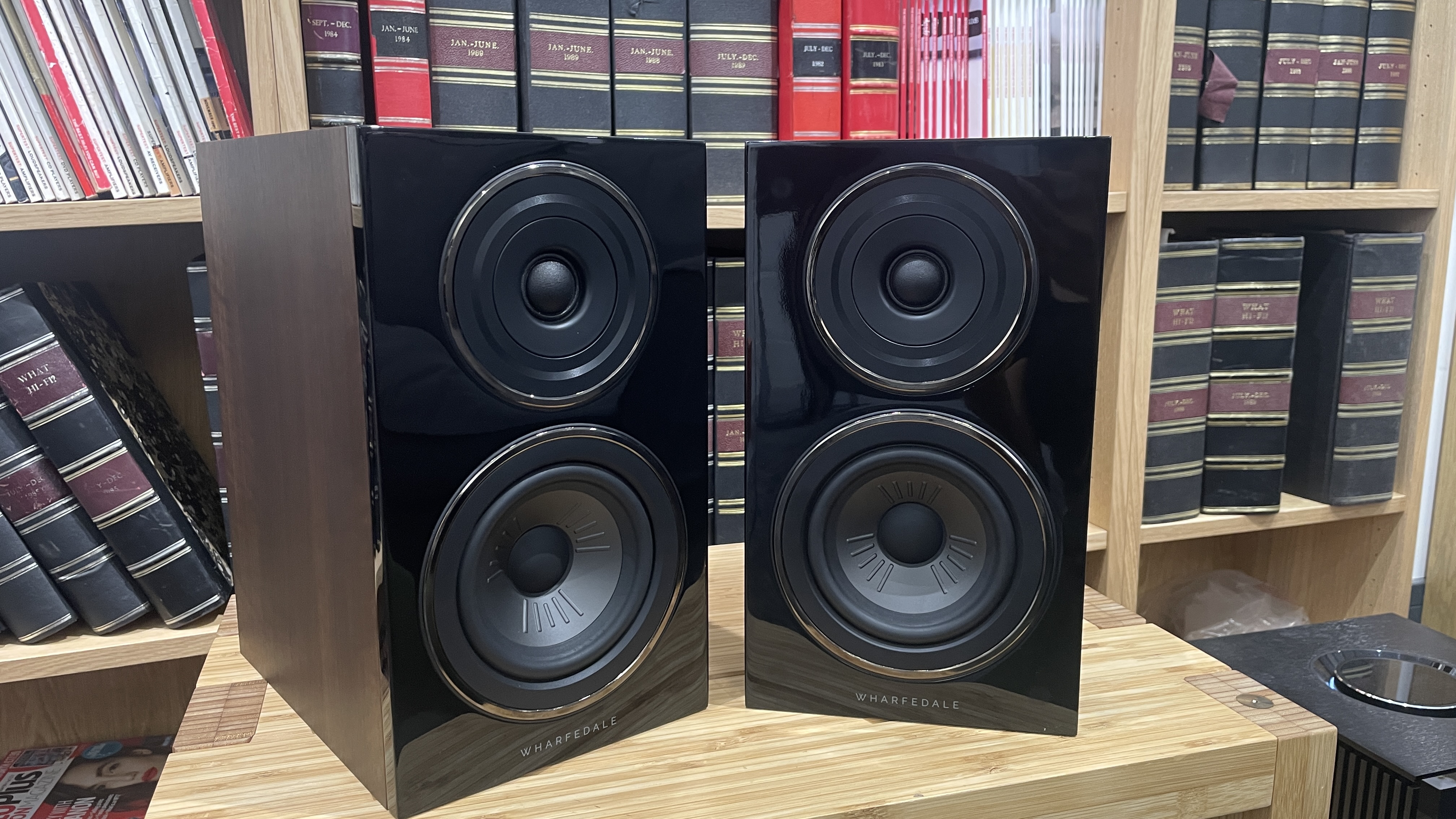 Wharfedale Diamond 12.1 stereo speakers in walnut veneer finish on a wooden rack