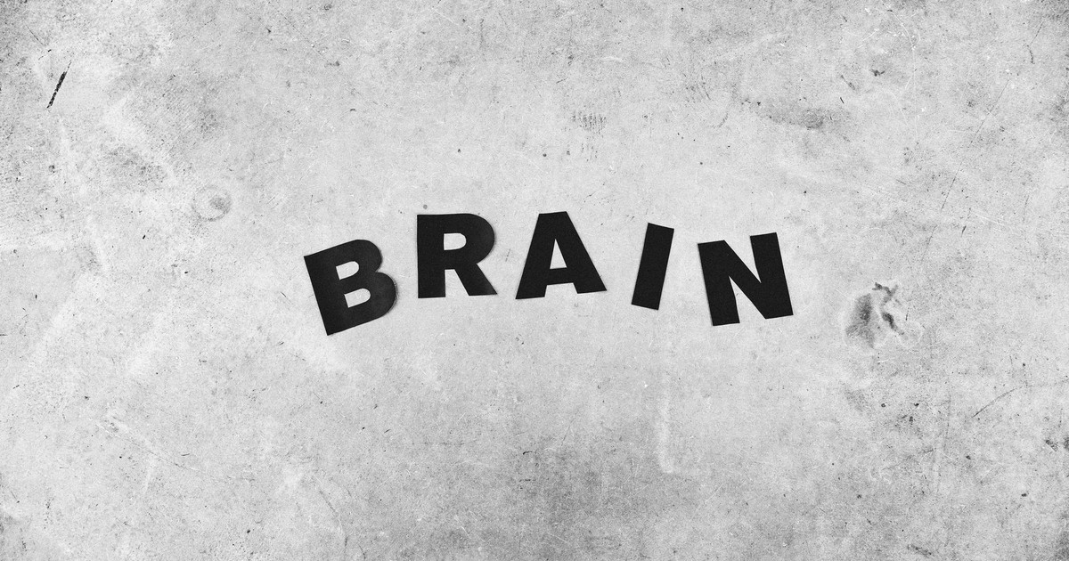 Black and white backdrop of Brain title with highlighted letters on gray wall with rough surface