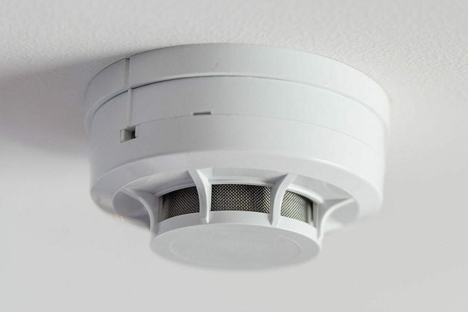 Close Up Smoke Detector On A Ceiling.