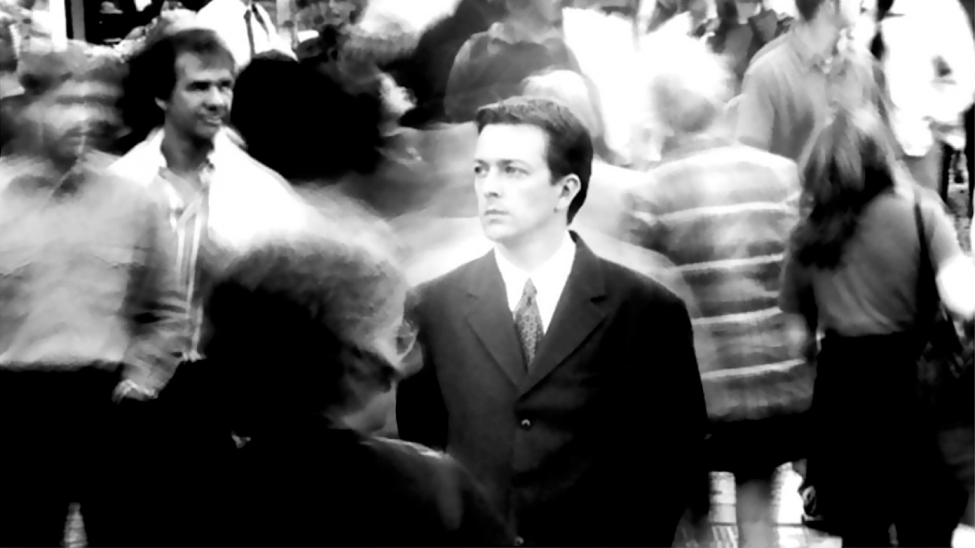 Jeremy Theobald as The Young Man Bill standing in a street during a scene in the Christopher Nolan movie, Following.
