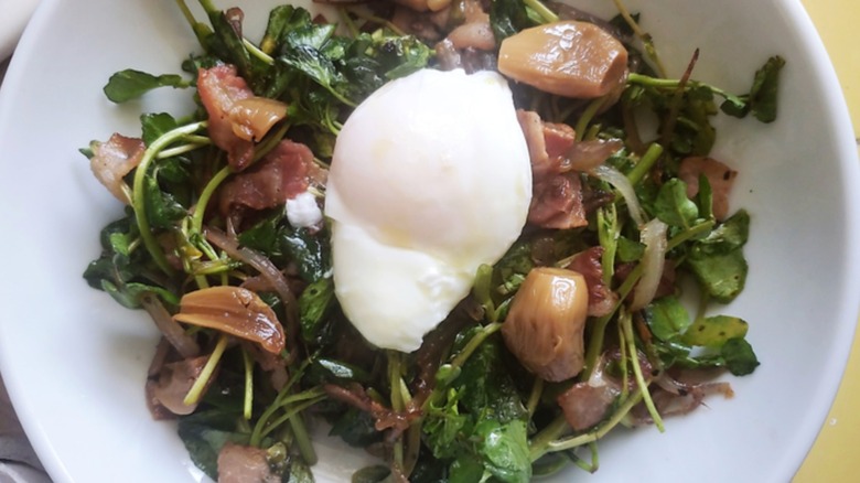 Poached egg on top of greens