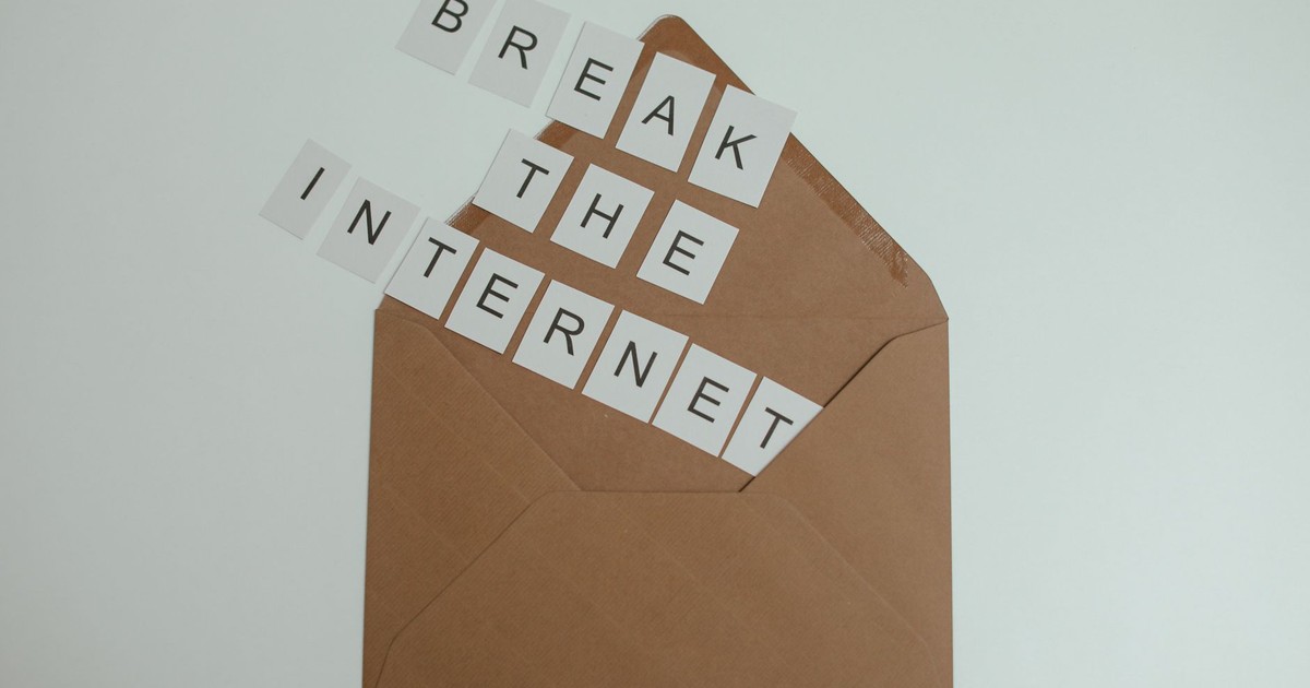 Brown envelope with tiles spelling 'Break the Internet' creates a conceptual and modern theme.