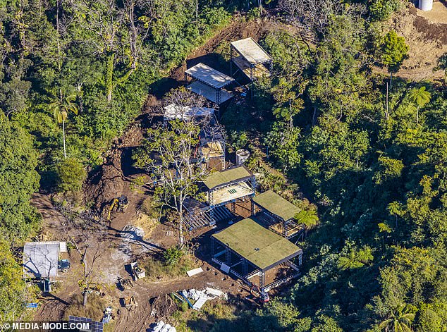 Construction materials, earthmoving equipment, solar panels and unfinished platforms can be seen scattered across the rugged bushland site, offering the clearest look yet at the scale of Efron's ambitious 'Futurecave' project