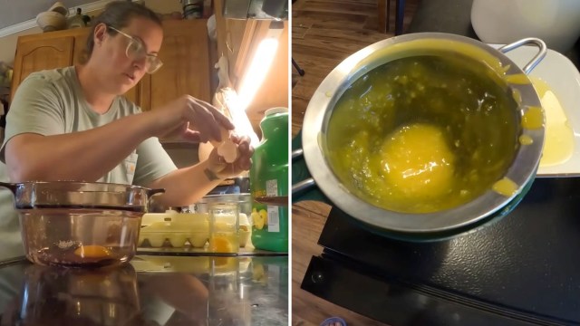 A person cracks eggs into a glass bowl while preparing food in a kitchen.
