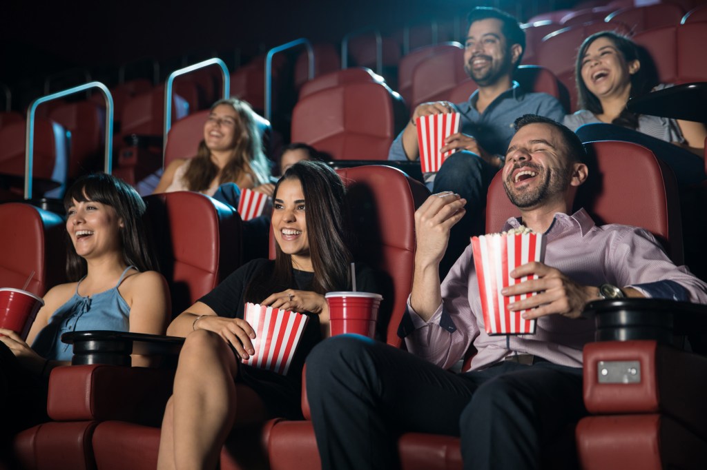 people laughing at the movie theater