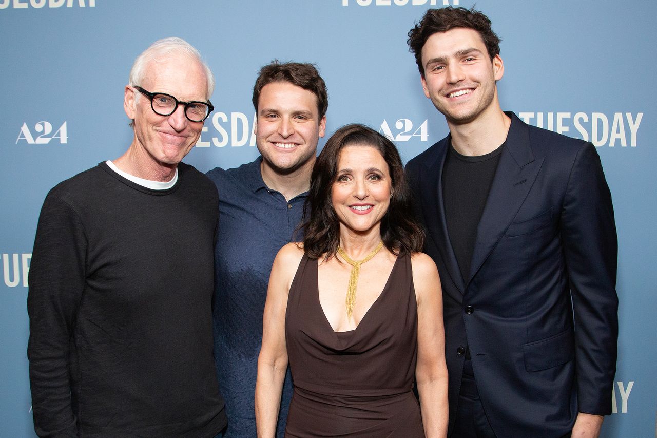 Brad Hall and Julia LouisDreyfus posing with two other individuals at an event