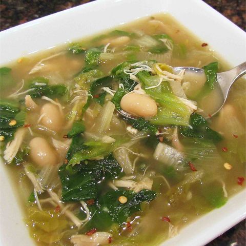 close up view of Beans and Greens soup in a white bowl