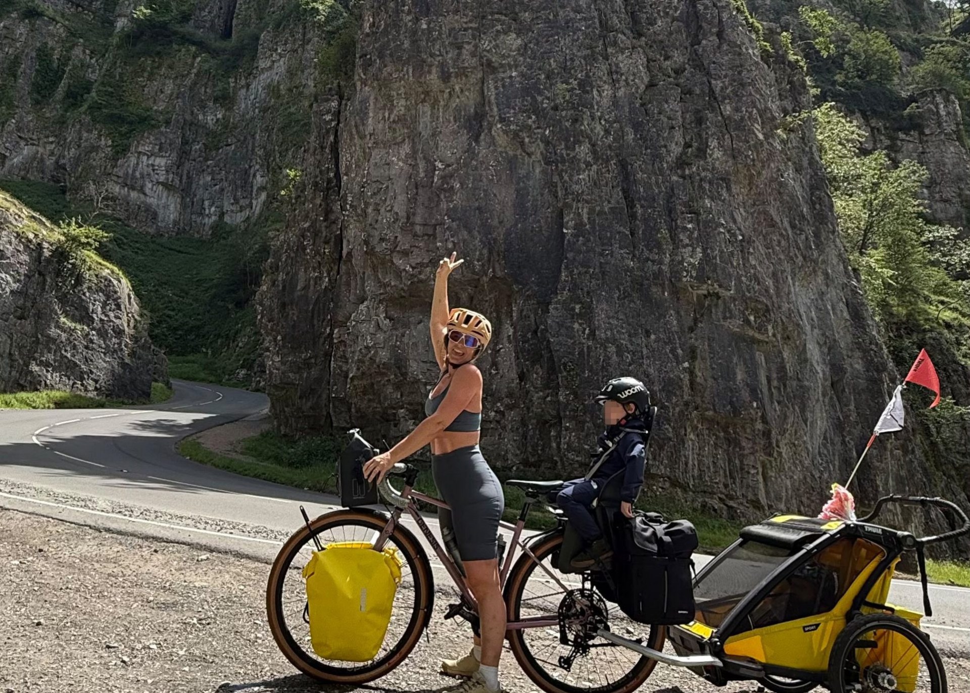Ro on her bike with her kids behind her