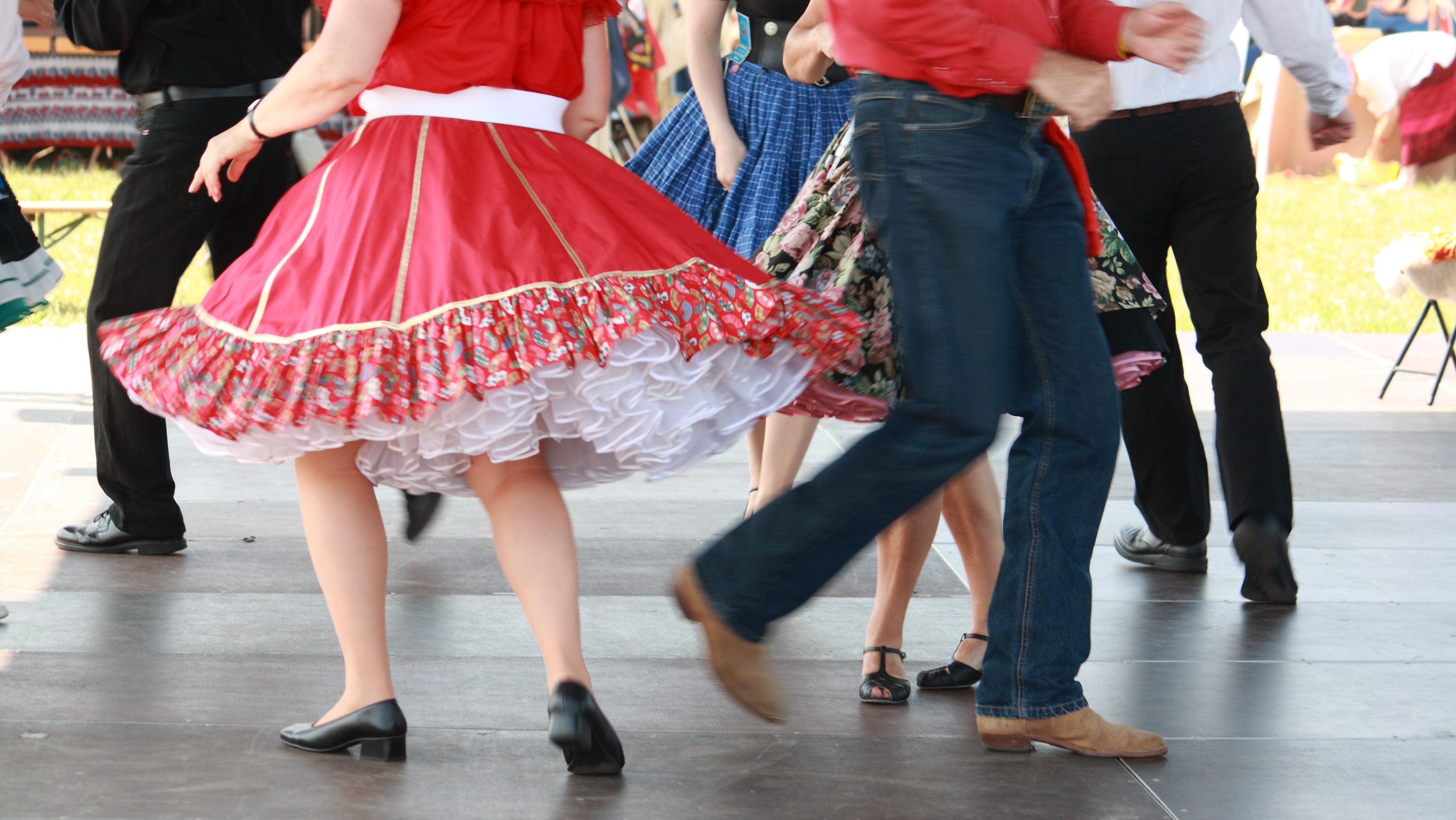 Group of people participating in a lively square dance.