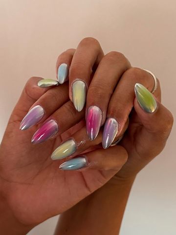 Hands showcasing painted fingernails with a gradient design
