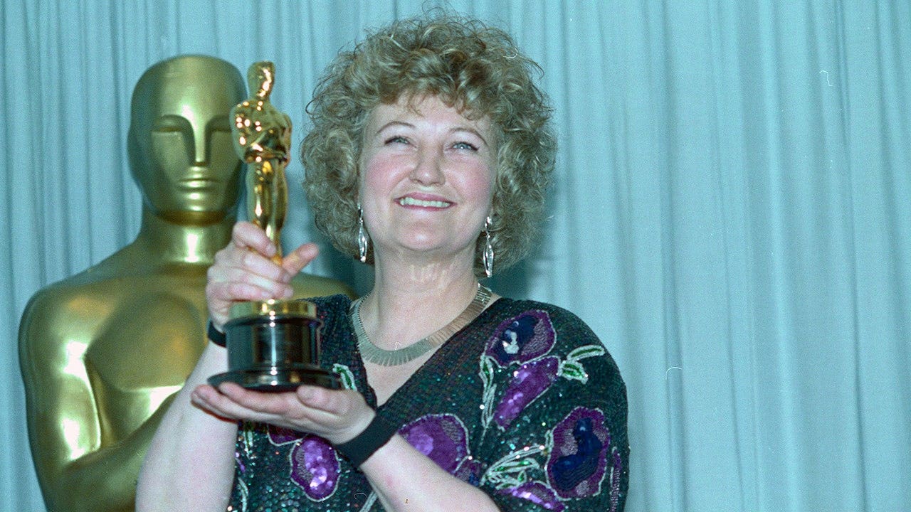 Brenda Fricker holds up her Oscar after winning best supporting actress for her role in 