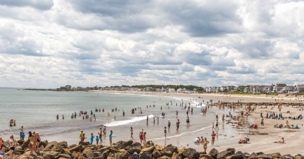 Visitors swim and play on the shores of Wallis Sands beach in Rye, New Hampshire.