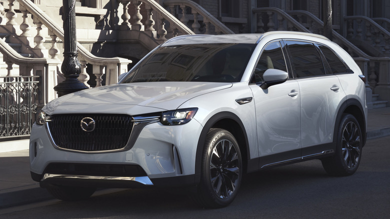 Front 3/4 view of Mazda CX-90 in urban setting