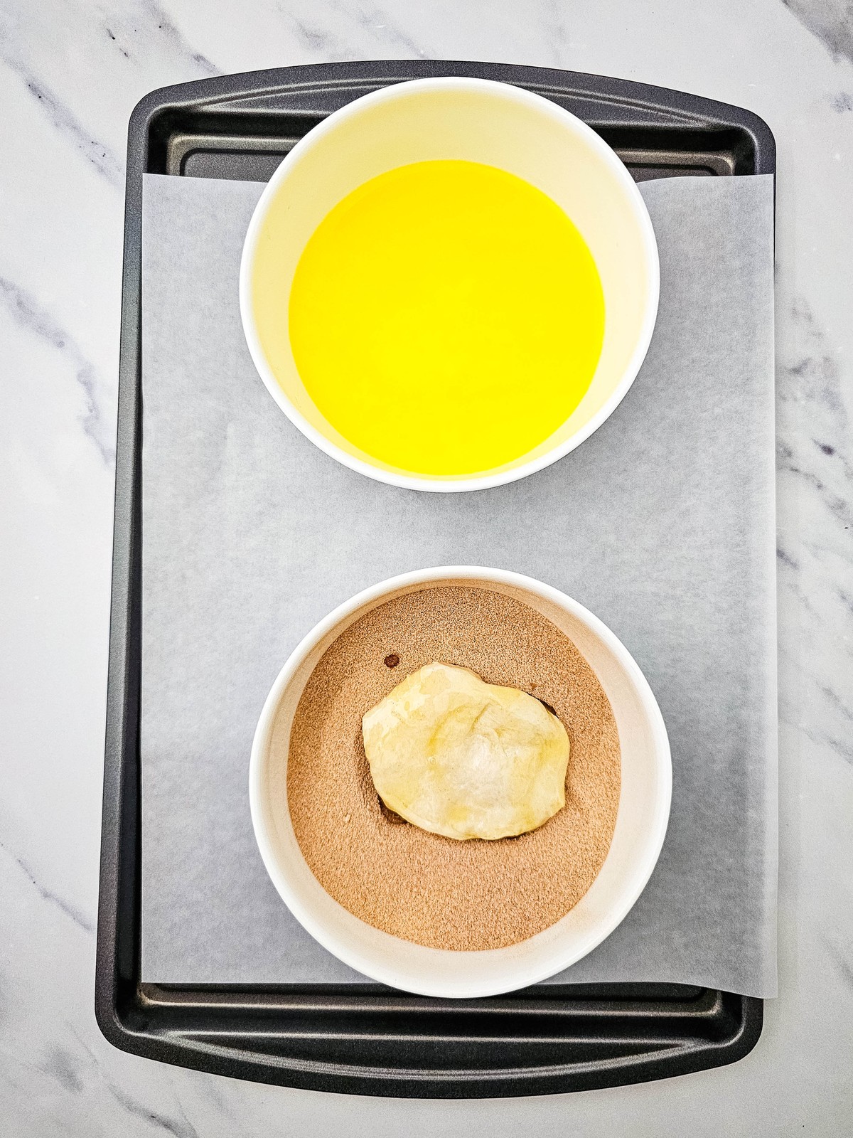 Dipping a biscuit round in melted butter