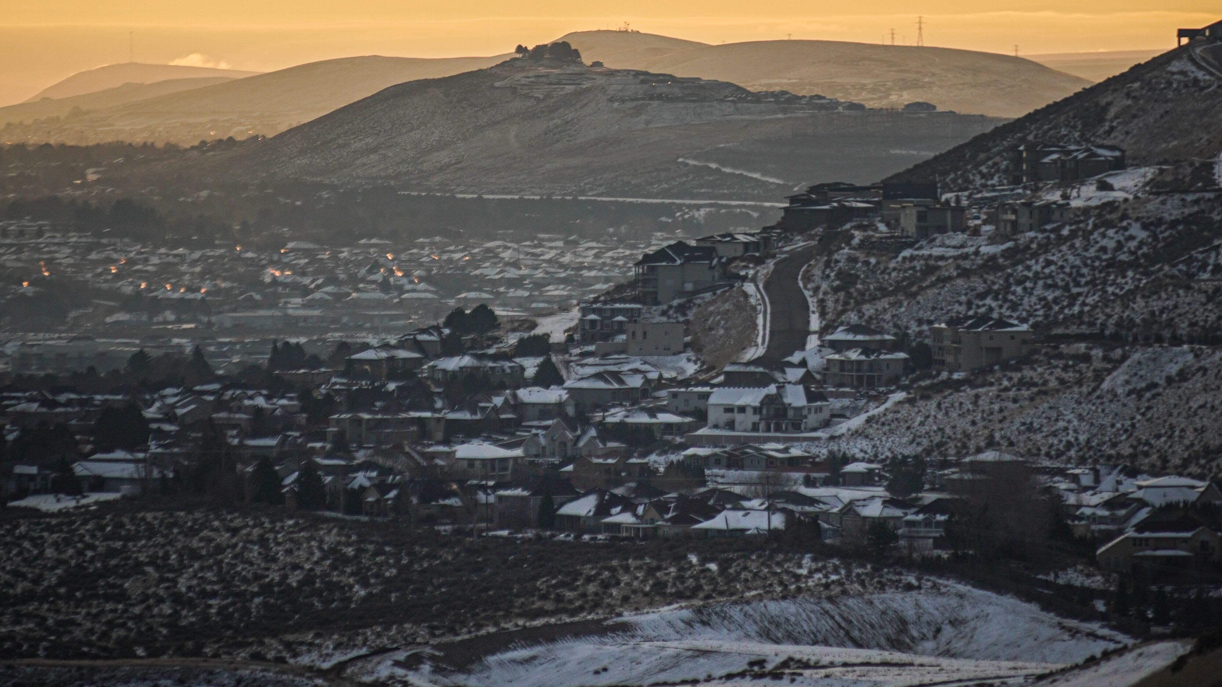 Winter sunset over snow-dusted hills and townscape Washington State.