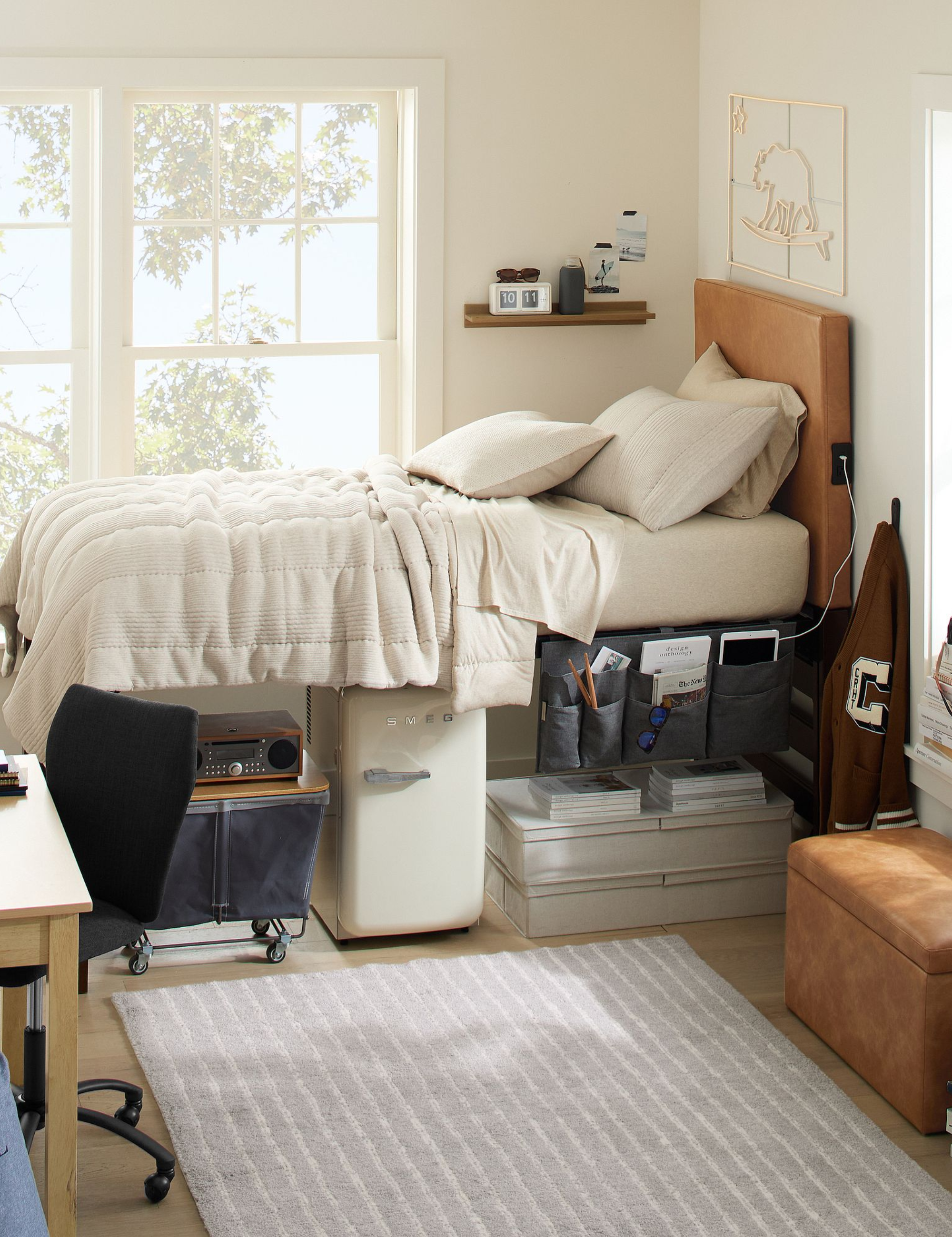 Neutral dorm room featuring a hanging bedside caddy