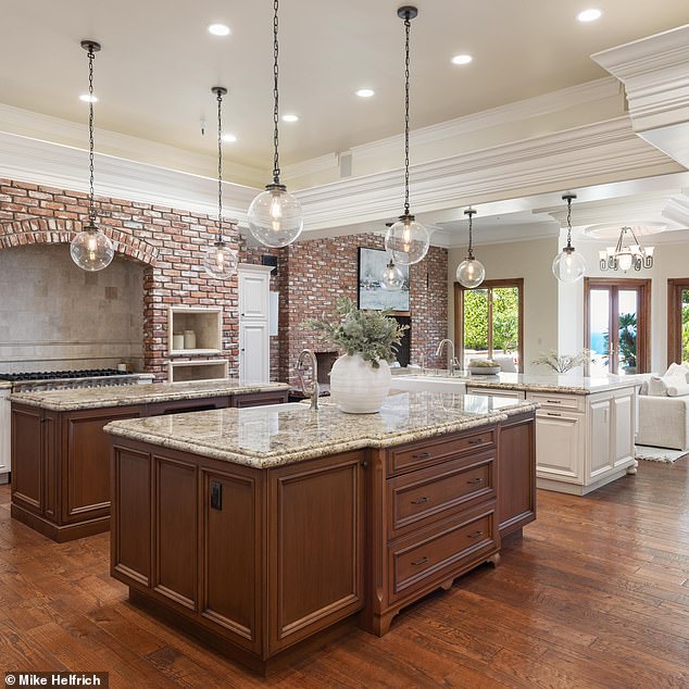 The kitchen features dual islands and chef standard appliances