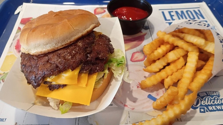 A Culver's butterburger and crinkle fries with a side of ketchup