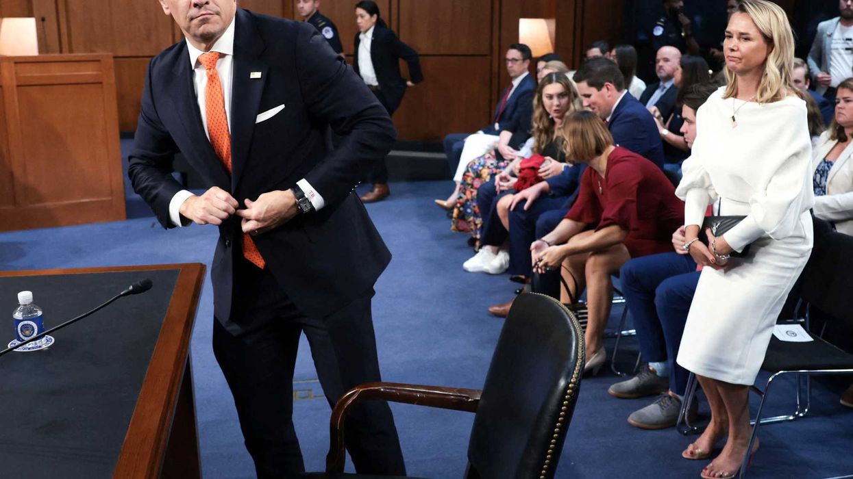 Acting U.S. Attorney General Todd Blanche, with his wife Kristine Blanche, buttons his coat to depart after testifying before a Senate Judiciary Committee confirmation hearing on his nomination to be attorney general, on Capitol Hill in Washington, D.C., U.S., July 15, 2026. REUTERS/Jonathan Ernst