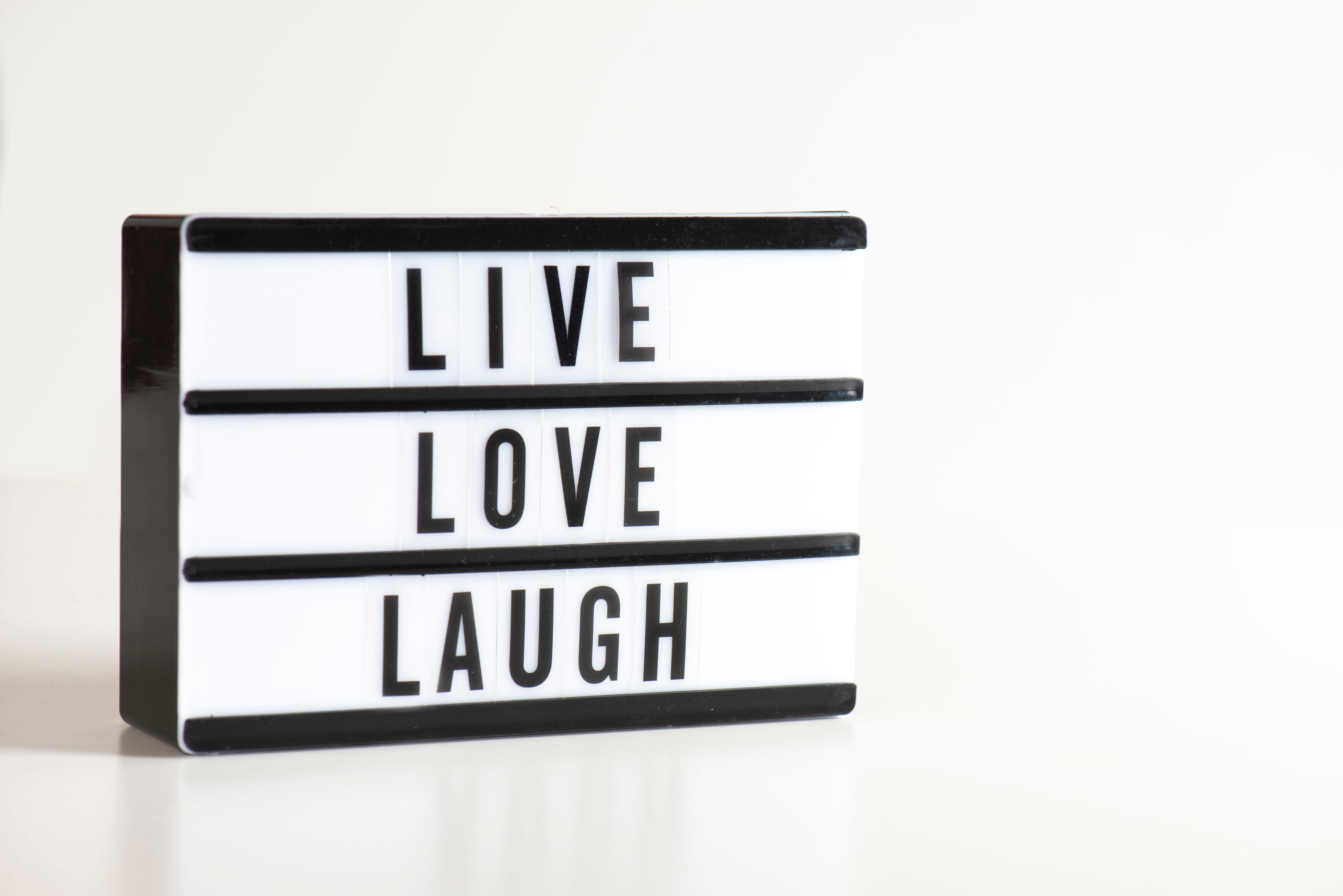 A marquee sign with "LIVE LOVE LAUGH"