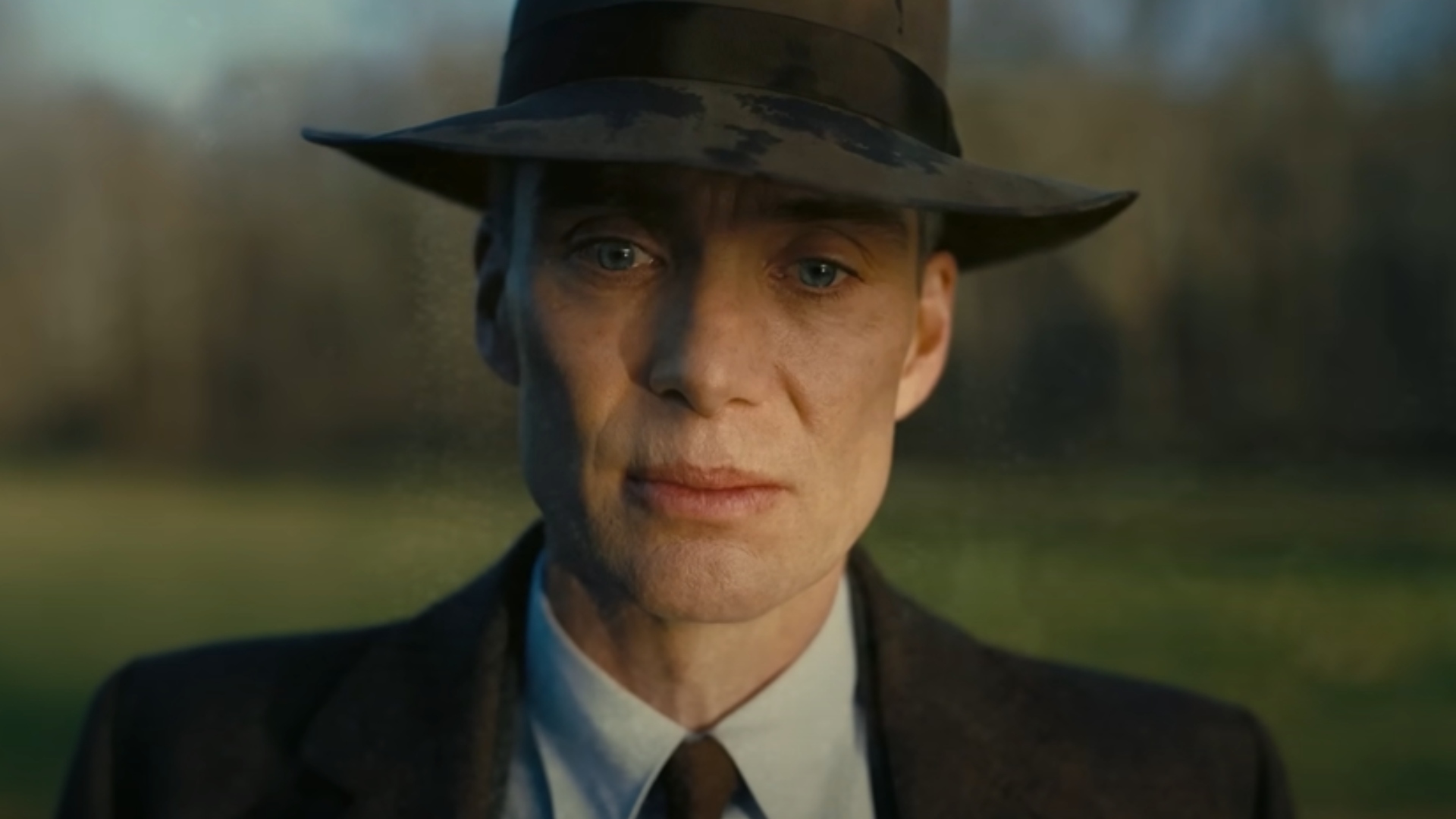 Cillian Murphy as J. Robert Oppenheimer looking sad during a scene in the Christopher Nolan movie, Oppenheimer