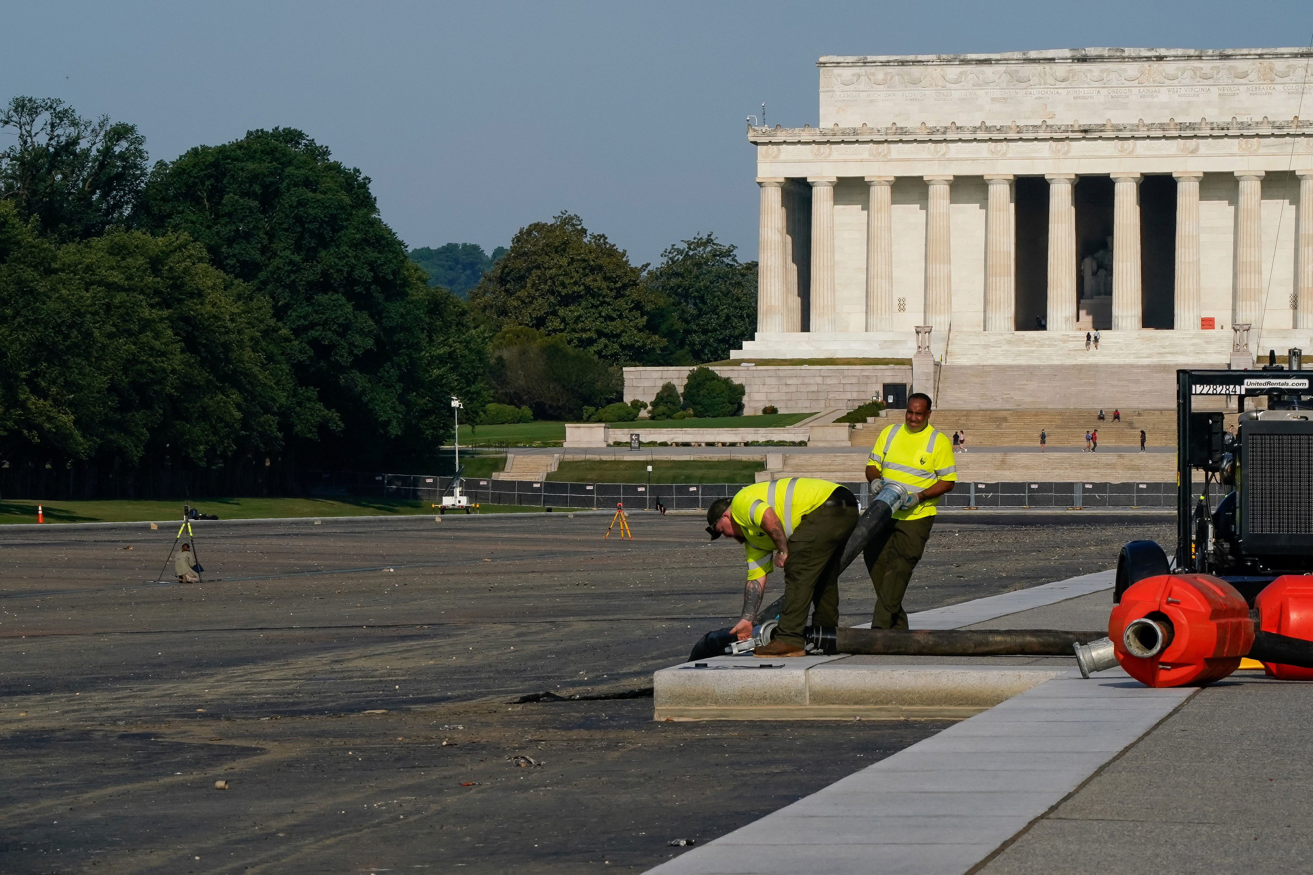 Workers remove equipment from the drained Lincoln Memorial Reflecting Pool on July 15, 2026. / Elizabeth Frantz/Reuters