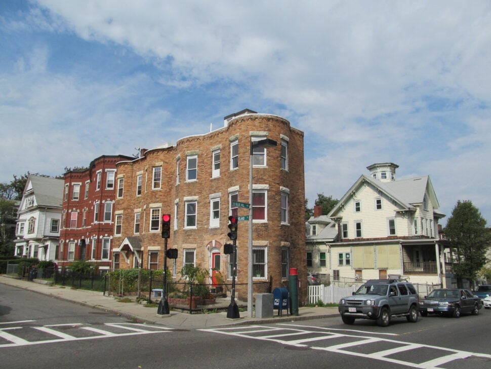 Historic brick rowhouses and Victorian homes at the intersection of Moreland Street and Blue Hill Avenue in Roxbury, Boston.