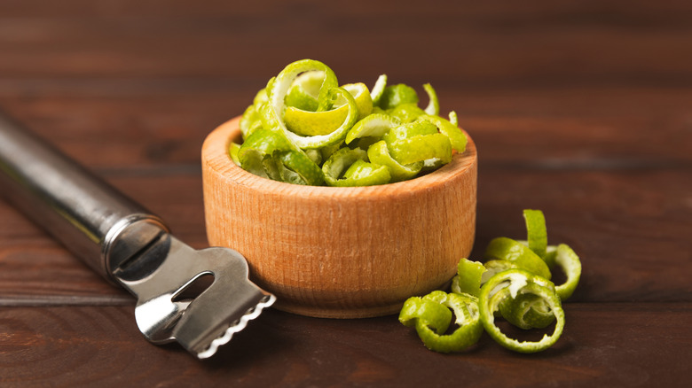 Fresh lime zest in small wooden bowl