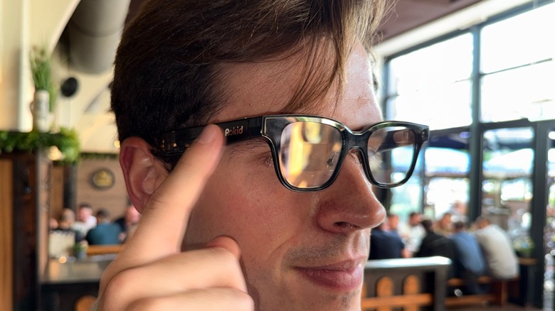 A man wearing smart glasses in a restaurant