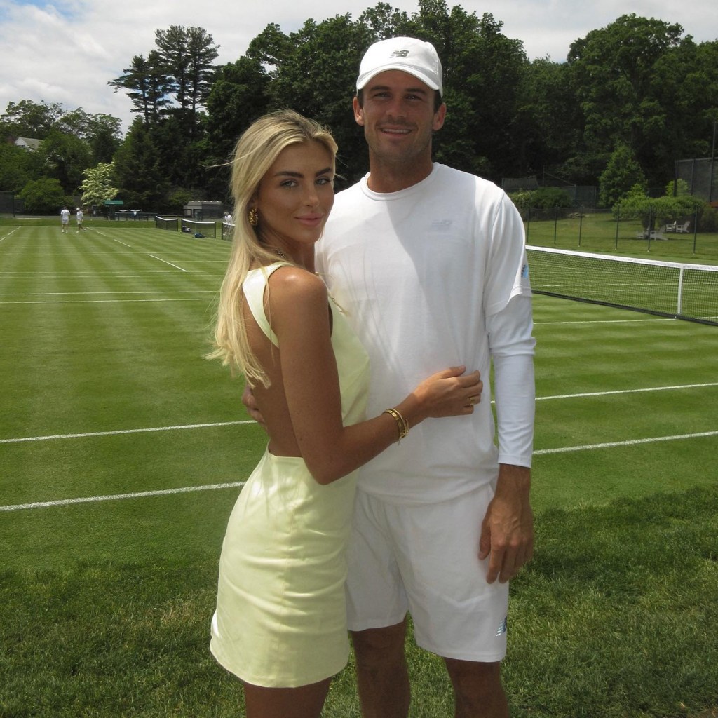 Paige Lorenze and Tommy Paul posing together on a tennis court.