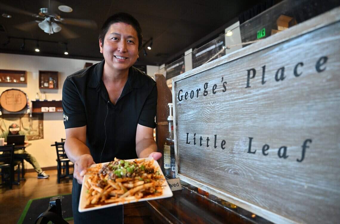 George Widjaja, owner of Little Leaf Bar & Restaurant, holds a plate of his kimchi fries, Wednesday, July 15, 2026 in Fresno.